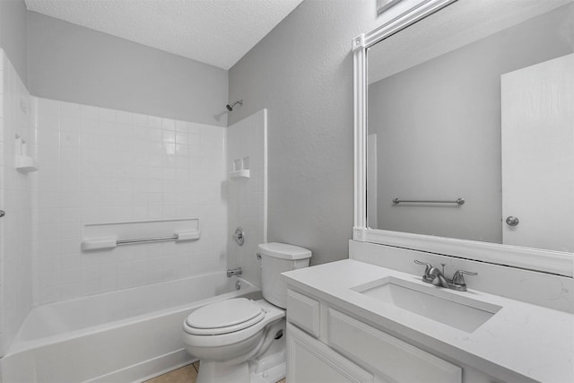 bathroom with shower / washtub combination, toilet, vanity, a textured wall, and a textured ceiling