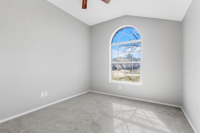 empty room featuring baseboards, lofted ceiling, carpet, and a ceiling fan