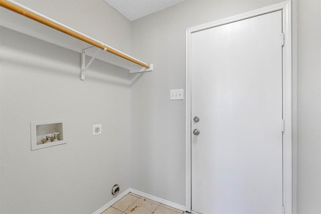 washroom with electric dryer hookup, washer hookup, light tile patterned floors, baseboards, and laundry area