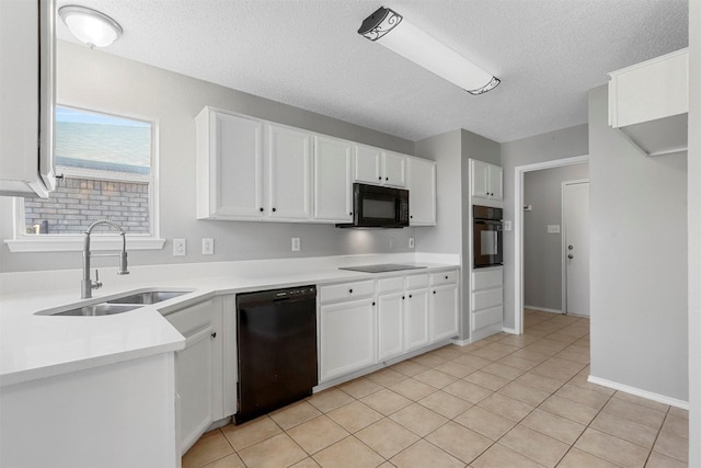 kitchen featuring black appliances, a sink, white cabinetry, light tile patterned flooring, and light countertops