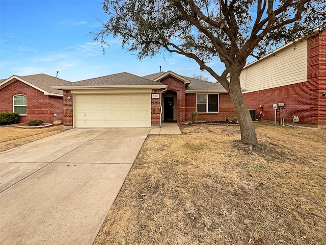 ranch-style home with brick siding, concrete driveway, roof with shingles, cooling unit, and a garage