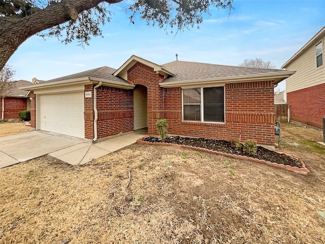 single story home featuring brick siding, concrete driveway, a garage, and a shingled roof