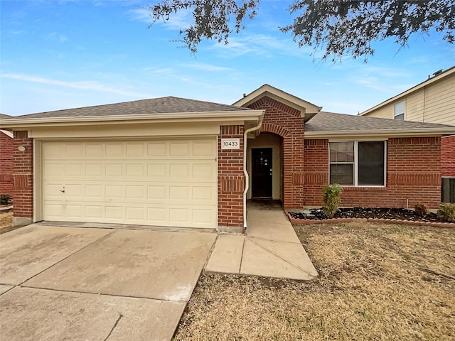 ranch-style house featuring brick siding, an attached garage, concrete driveway, and a shingled roof