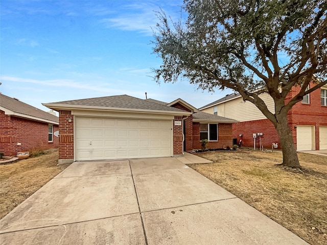 single story home with brick siding, an attached garage, driveway, and roof with shingles