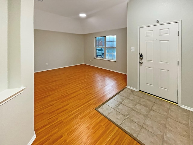 foyer entrance featuring wood finished floors and baseboards