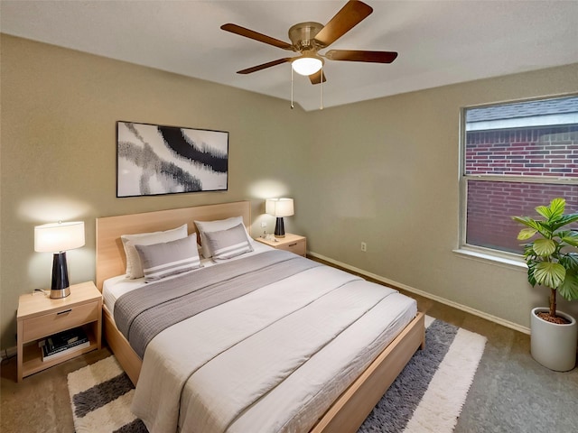 bedroom with a ceiling fan and baseboards