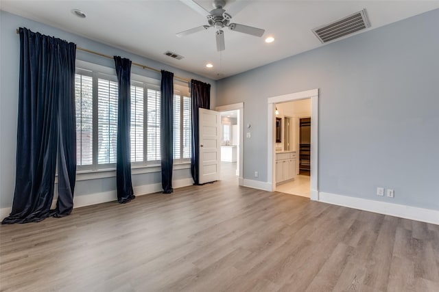 spare room featuring recessed lighting, wood finished floors, visible vents, and baseboards