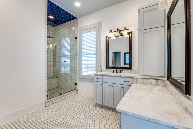 bathroom featuring recessed lighting, baseboards, vanity, and a shower stall