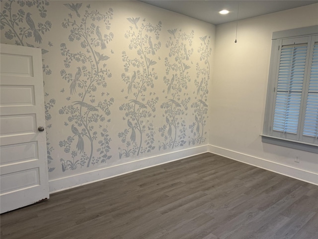 unfurnished room featuring dark wood finished floors and baseboards