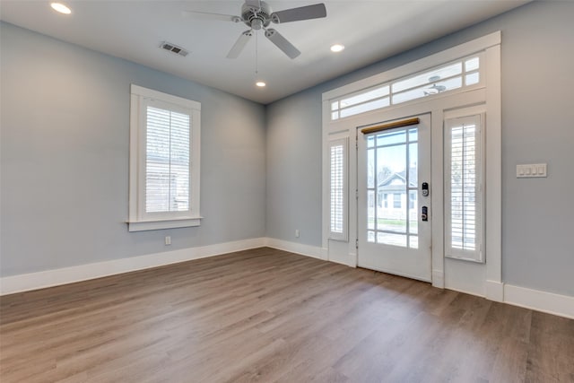 entryway with recessed lighting, wood finished floors, visible vents, and baseboards