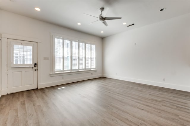 interior space with a ceiling fan, wood finished floors, visible vents, baseboards, and recessed lighting