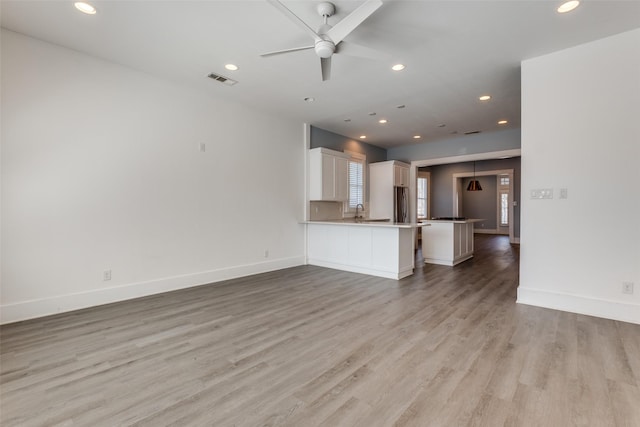 unfurnished living room featuring recessed lighting, visible vents, baseboards, and light wood-style flooring