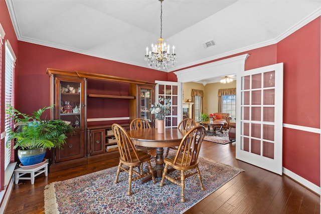 dining area featuring visible vents, baseboards, dark wood-style flooring, french doors, and crown molding