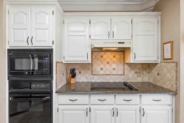 kitchen with dark stone counters, black appliances, under cabinet range hood, white cabinetry, and tasteful backsplash