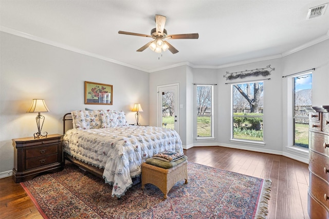 bedroom featuring access to exterior, visible vents, baseboards, dark wood finished floors, and ornamental molding