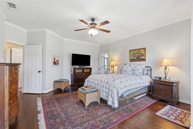 bedroom with visible vents, crown molding, baseboards, and wood-type flooring