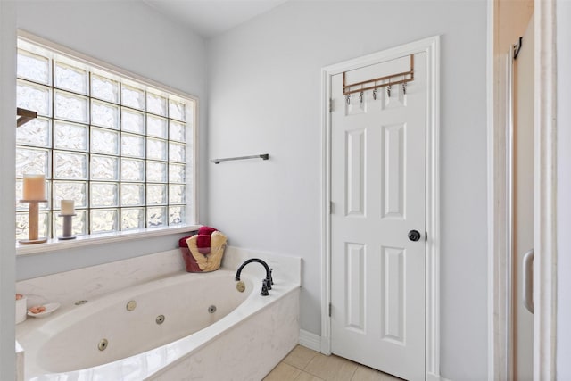 full bathroom featuring tile patterned floors and a jetted tub