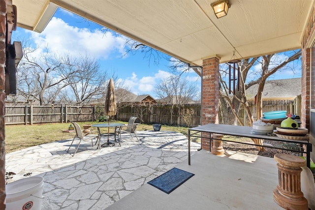 view of patio with outdoor dining area and a fenced backyard