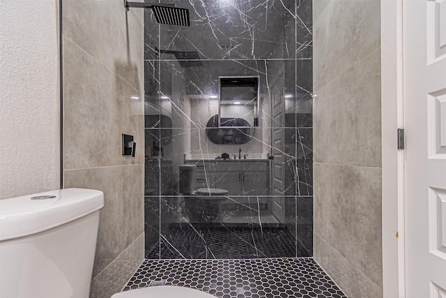 bathroom with toilet and a shower stall