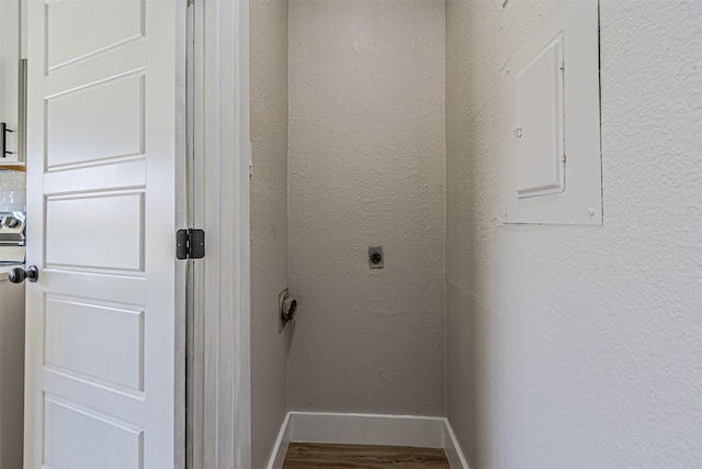 details with electric panel, baseboards, wood finished floors, and a textured wall