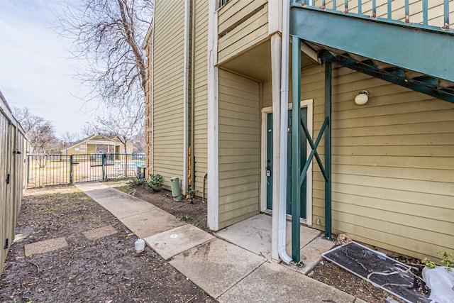 view of side of property with a gate and fence