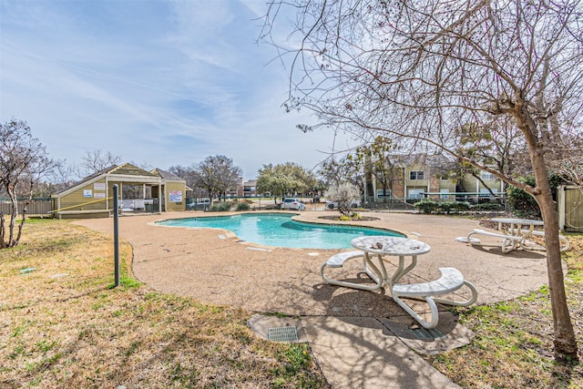 community pool featuring a patio area and fence