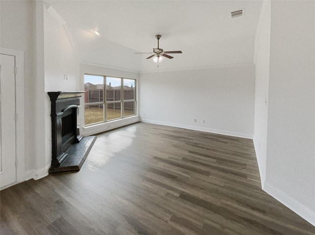 unfurnished living room with visible vents, baseboards, a fireplace with raised hearth, and dark wood-style flooring