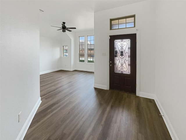 foyer with dark wood finished floors, ceiling fan, and baseboards