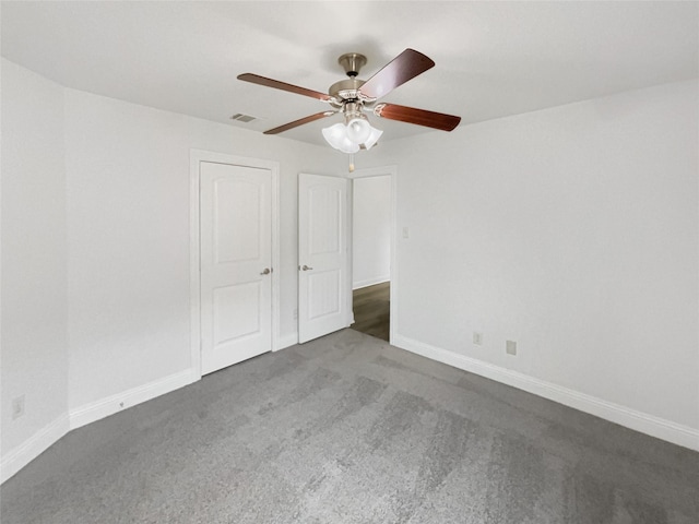 unfurnished bedroom with visible vents, carpet flooring, baseboards, and ceiling fan