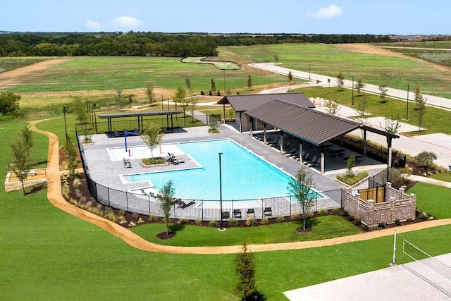 community pool featuring a gazebo, a rural view, a patio, and fence