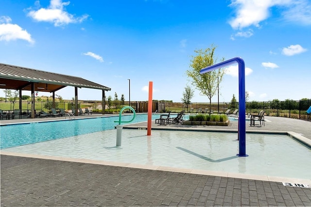 view of swimming pool featuring fence