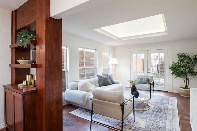 living area with ceiling fan, visible vents, and wood finished floors