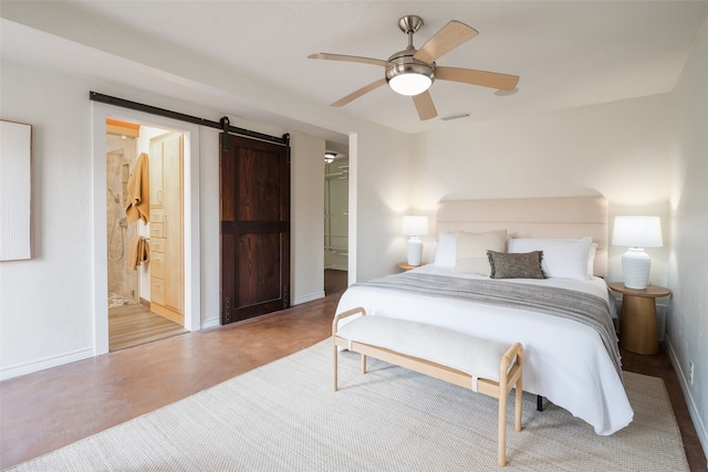 bedroom with connected bathroom, concrete flooring, visible vents, a barn door, and baseboards