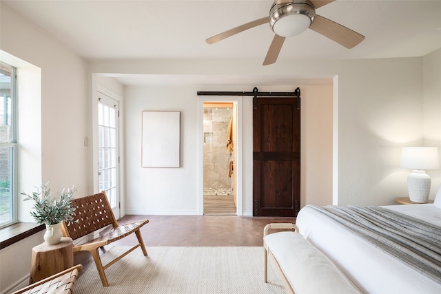 bedroom with baseboards, multiple windows, finished concrete floors, and a barn door