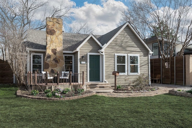 bungalow-style home featuring a front lawn and a shingled roof