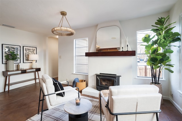 living area featuring baseboards and visible vents