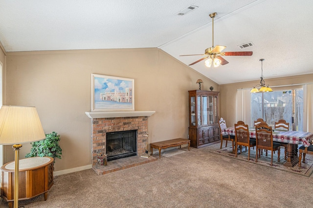 6908 Sunnybank Dr, Fort Worth, TX 76137 - dining room with carpet floors, vaulted ceiling, a ceiling fan, and a fireplace