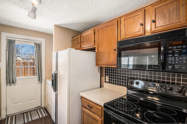6908 Sunnybank Dr, Fort Worth, TX 76137 - kitchen featuring black appliances, backsplash, brown cabinetry, light countertops, and a textured ceiling