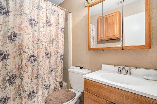 6908 Sunnybank Dr, Fort Worth, TX 76137 - full bath with a textured wall, vanity, toilet, and shower / bath combo