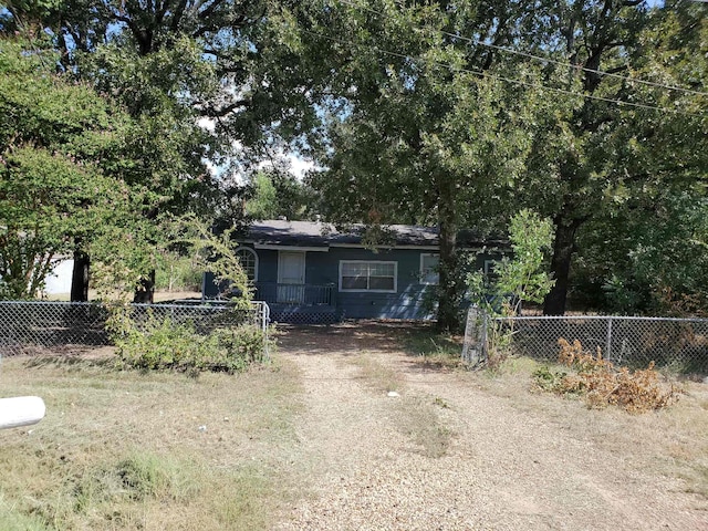 view of front of property with driveway and fence