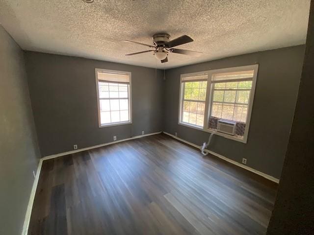 unfurnished room featuring a healthy amount of sunlight, baseboards, and dark wood-style flooring