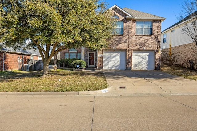 traditional-style house featuring driveway, a front yard, a garage, brick siding, and central AC unit