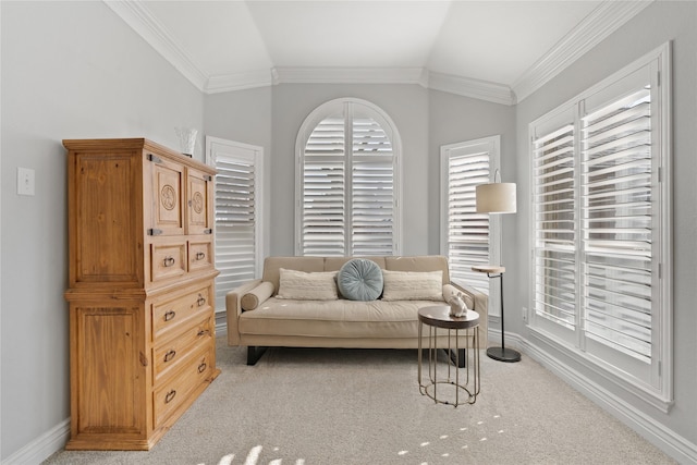 living area featuring light colored carpet, crown molding, baseboards, and vaulted ceiling