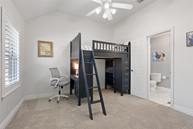 bedroom featuring baseboards, visible vents, carpet floors, vaulted ceiling, and connected bathroom