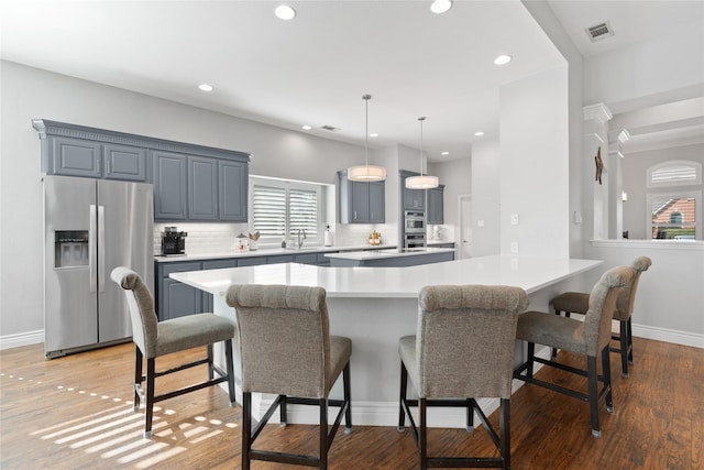 kitchen featuring light countertops, a healthy amount of sunlight, visible vents, and appliances with stainless steel finishes