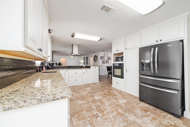 kitchen with visible vents, oven, refrigerator with ice dispenser, a peninsula, and a sink