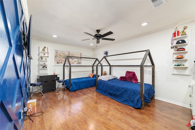 bedroom with wood finished floors, visible vents, recessed lighting, ceiling fan, and crown molding