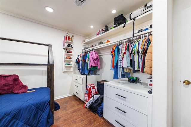 walk in closet with visible vents and dark wood finished floors