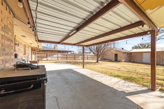 view of patio featuring an outdoor structure and fence