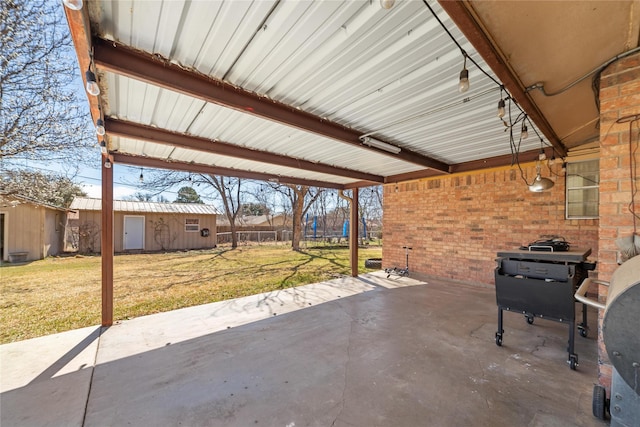 view of patio / terrace with an outbuilding, a carport, and fence